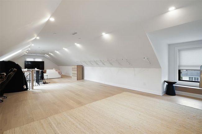 Bonus room with lofted ceiling, baseboards, and wood finished floors | Image 27