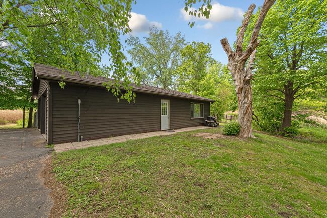 Garage with additional living quarters in the rear of the garage. The living quarters has heat and air conditioning. | Image 11