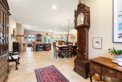 Enter into the open concept living area, featuring Italian porcelain tile and tall ceilings. | Image 3