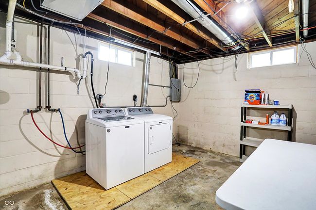 washroom featuring washing machine and clothes dryer and healthy amount of natural light | Image 22