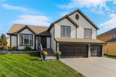 View of front of home featuring a front lawn and a garage | Image 1