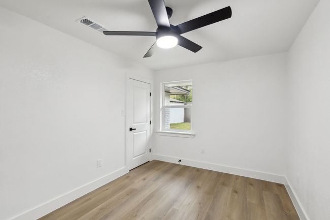 Spare room featuring a ceiling fan, light wood-style flooring, baseboards, and visible vents | Image 20