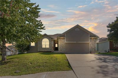 Ranch-style home with a garage and a yard | Image 2