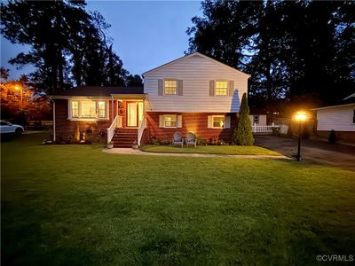 Split level home featuring a yard | Image 1