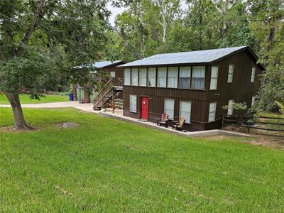 This 3 bedroom house has a detached 2 car garage with an upstairs apartment and sits on 3 lots. and a large producing Pecan tree in the front yard. | Image 1