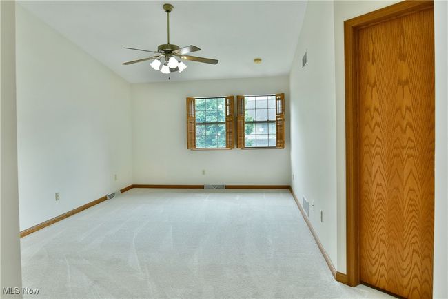Empty room featuring ceiling fan and light carpet | Image 35