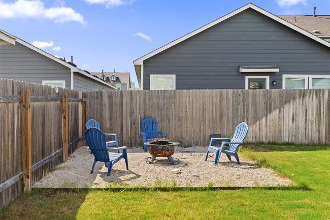Fenced backyard with a fire pit | Image 16