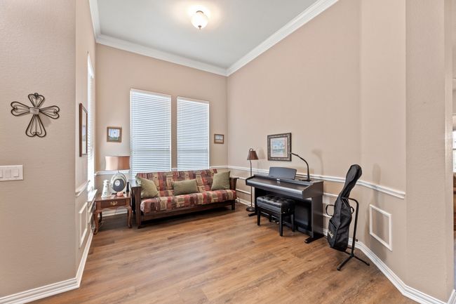 Office area featuring crown molding, wood finished floors, and baseboards | Image 10
