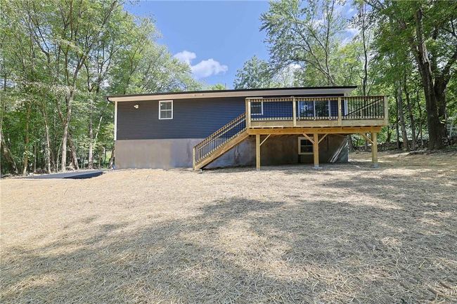 Back of house with a wooden deck | Image 25