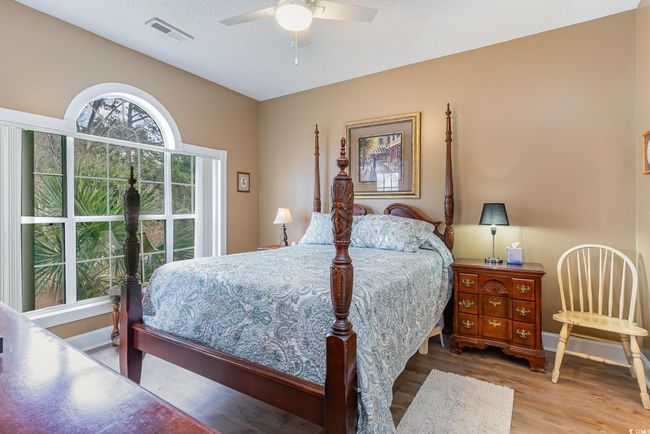 Bedroom with ceiling fan, hardwood / wood-style floors, and a textured ceiling | Image 10
