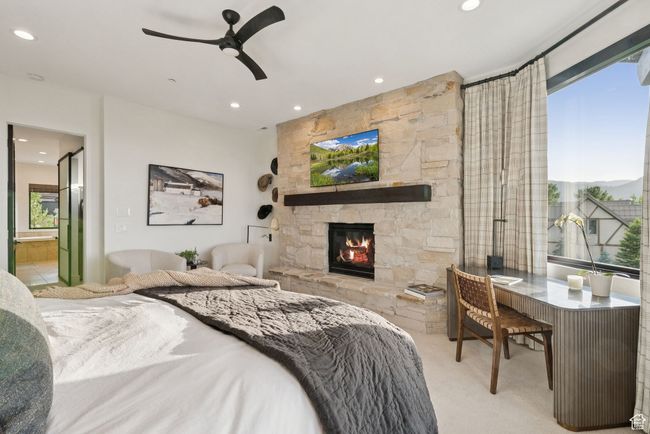 Bedroom with carpet flooring, recessed lighting, a stone fireplace, and ensuite bath | Image 37