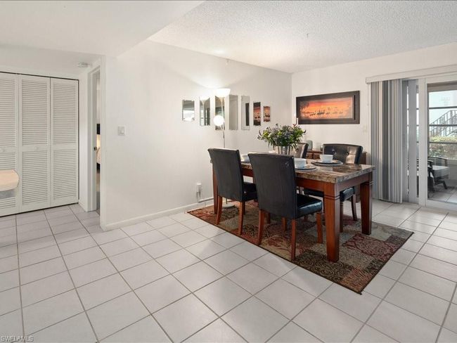 Dining area with light tile patterned floors | Image 22