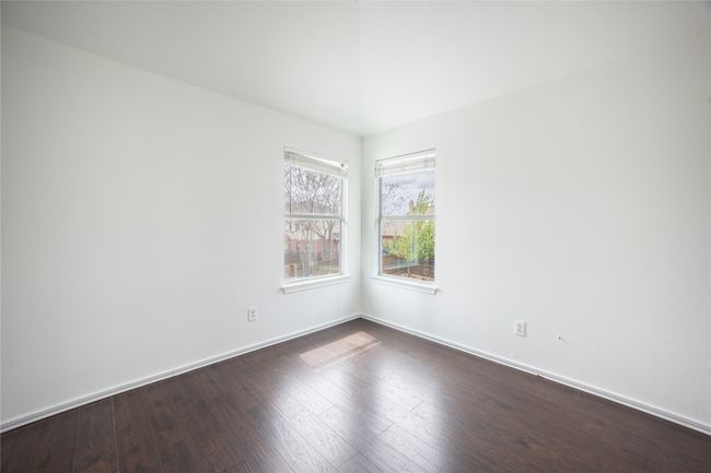 Spare room featuring baseboards and dark wood-style flooring | Image 10
