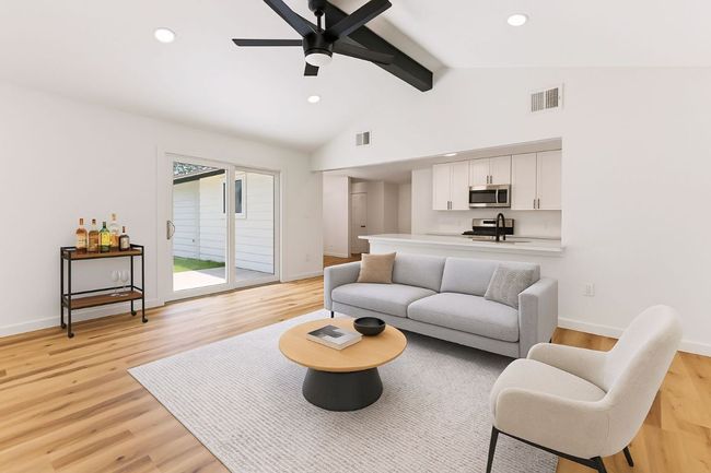 Living area with beamed ceiling, light wood-style floors, ceiling fan, recessed lighting, and high vaulted ceiling | Image 15