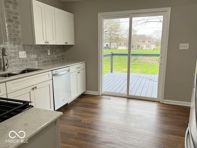 Patio doors open onto the spacious rear deck | Image 17