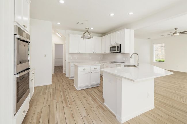 Gourmet Kitchen with Quartz Countertops and Stainless Steel Appliances and Island | Image 11