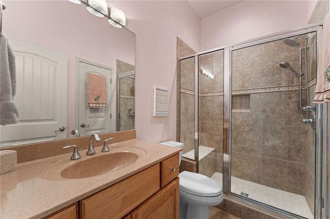 Bathroom featuring toilet, vanity, and a shower stall | Image 46