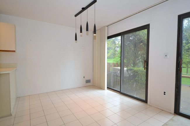 Unfurnished dining area with a wealth of natural light and visible vents | Image 8