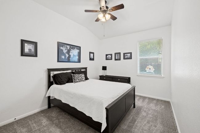 Carpeted bedroom with vaulted ceiling and ceiling fan | Image 21