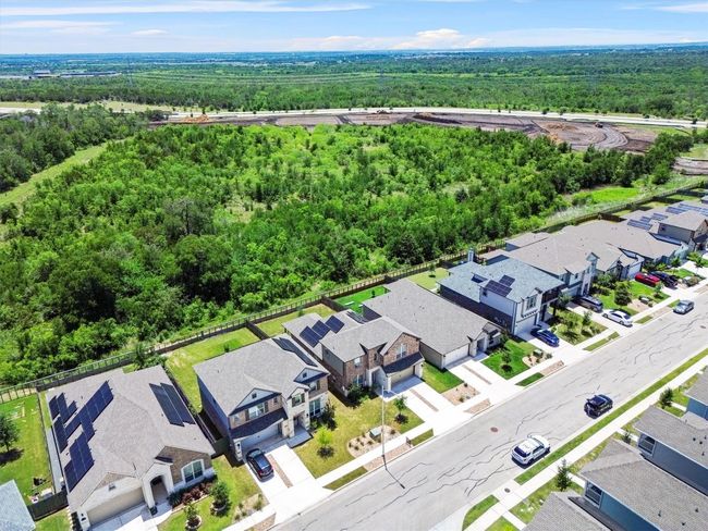 Aerial perspective of suburban area with a forest | Image 25