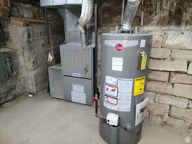 Utility room featuring gas water heater | Image 38