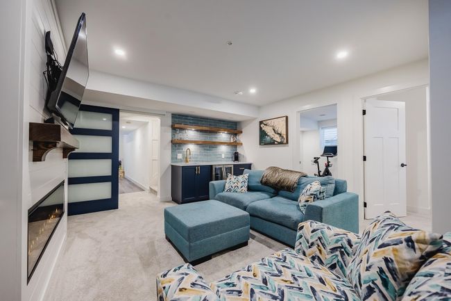 Living area with light carpet, baseboards, a fireplace, and recessed lighting | Image 27