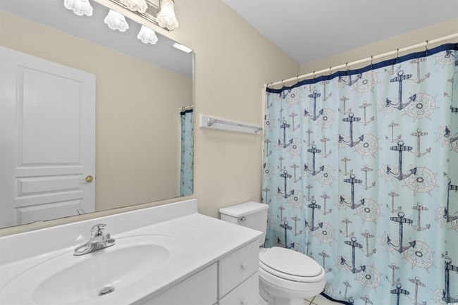 Full bath with vanity, toilet, and curtained shower | Image 23