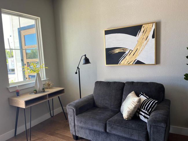 Living room featuring wood finished floors and baseboards | Image 8