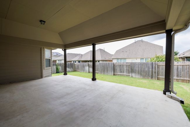 Fenced backyard featuring a patio area and a residential view | Image 29