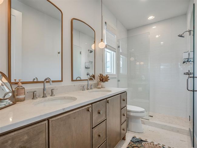 Bathroom with a shower stall, toilet, double vanity, and recessed lighting | Image 28