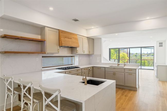 Kitchen with C-shaped countertops | Image 9