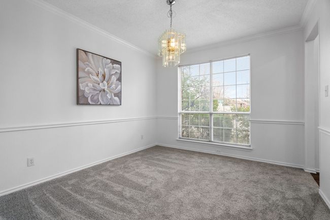 The formal dining room has crown and chair molding. | Image 8