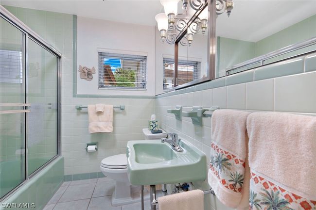 Full bathroom with toilet, tile patterned floors, tasteful backsplash, and tile walls | Image 34