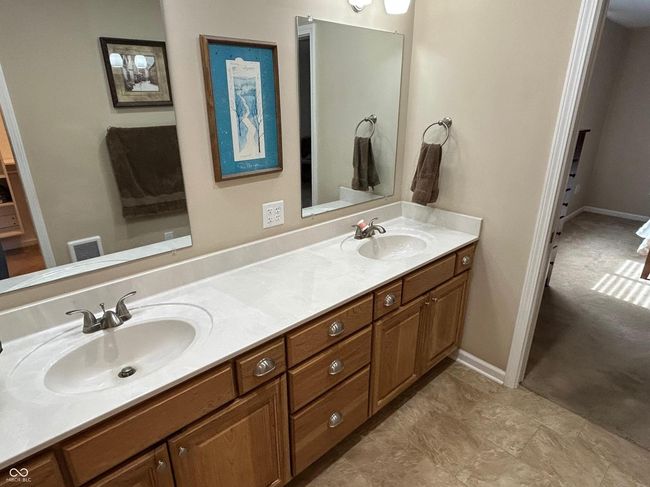 ensuite bathroom with ensuite bathroom, baseboards, a sink, and double vanity | Image 18