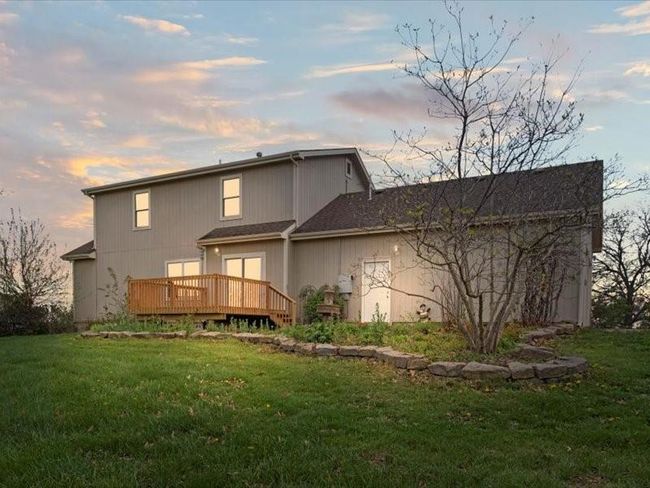 Rear view of property featuring a wooden deck and a yard | Image 49