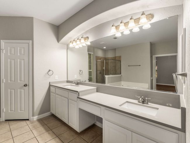 Bathroom featuring a shower stall, tile patterned floors, and a sink | Image 17