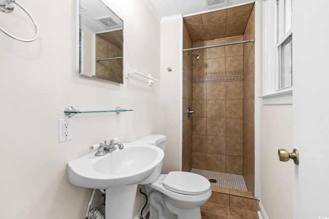 Full bath with a stall shower, toilet, and tile patterned flooring | Image 30
