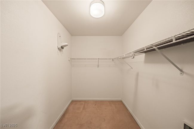 Walk in closet with light carpet | Image 19