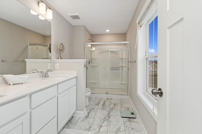 Ensuite primary spa-like bathroom boasts a large walk-in shower, dual vanities and abundant storage. | Image 14