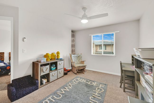 Interior space featuring carpet, baseboards, and ceiling fan | Image 12