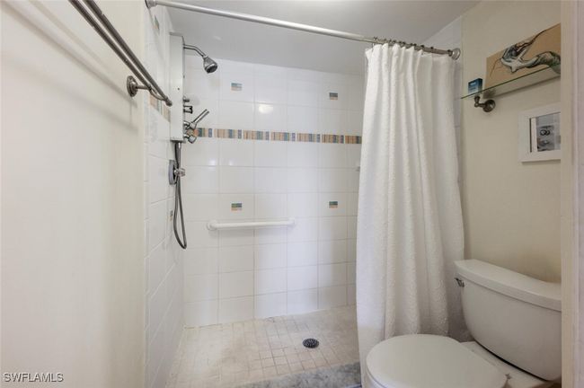 Bathroom with toilet and a stall shower | Image 12