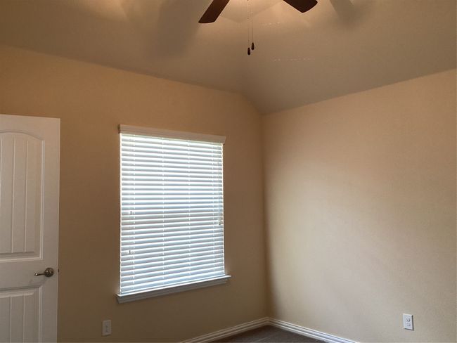 Empty room featuring a ceiling fan and baseboards | Image 31