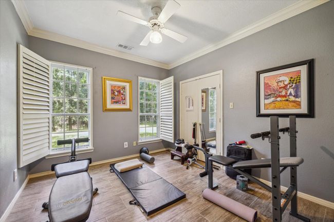 Charming two-story home with a welcoming front porch, nestled among mature trees. Features dormer windows, a classic gable roof, and a spacious yard, perfect for enjoying nature and outdoor activities. | Image 11