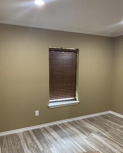 Unfurnished room with hardwood / wood-style floors and ornamental molding | Image 2