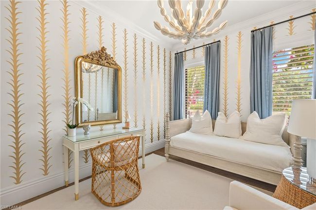 Sitting room featuring a chandelier, a wealth of natural light, crown molding, baseboards, and wallpapered walls | Image 33