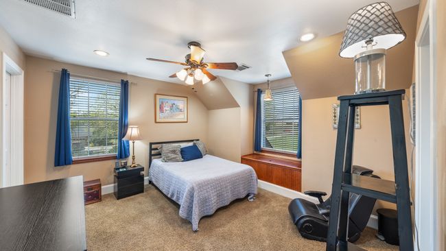 Carpeted bedroom with baseboards, visible vents, and multiple windows | Image 23