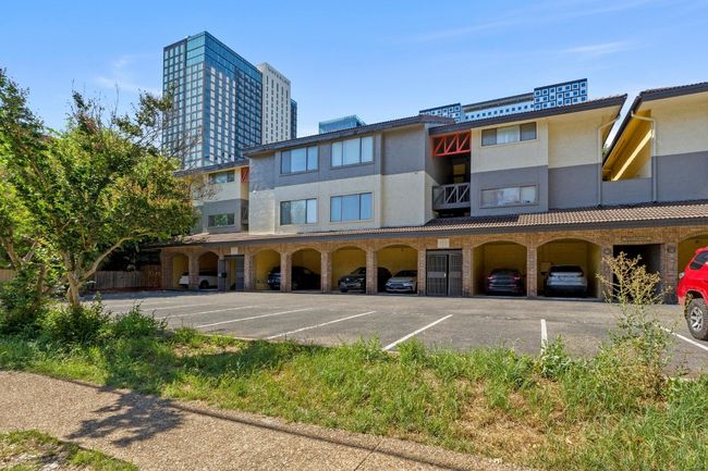 The home comes with 2 assigned parking spaces, 1 covered and 1 uncovered. | Image 4