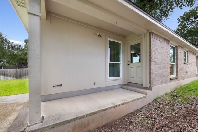 View of exterior entry with brick siding | Image 35