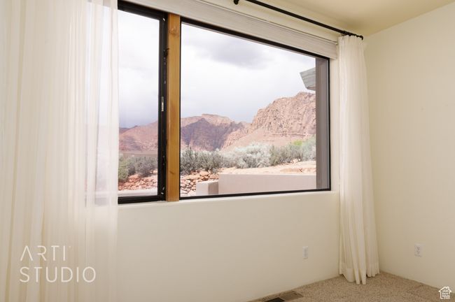 Empty room featuring carpet, a mountain view, and visible vents | Image 32