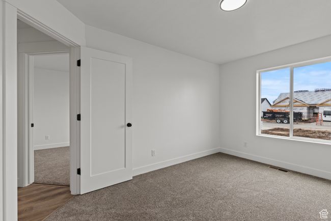 Carpeted spare room with baseboards | Image 15